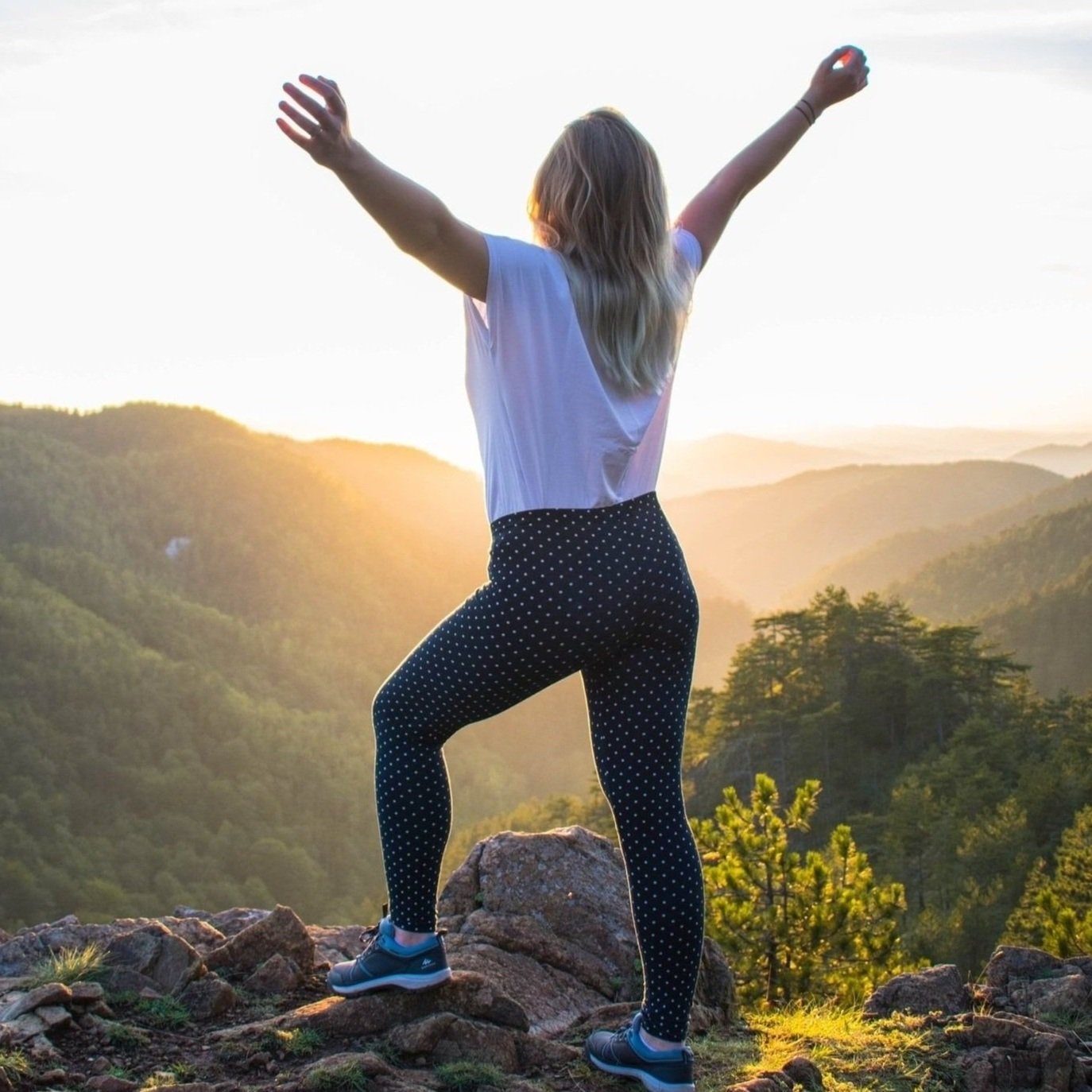 woman raising her arms and feeling free