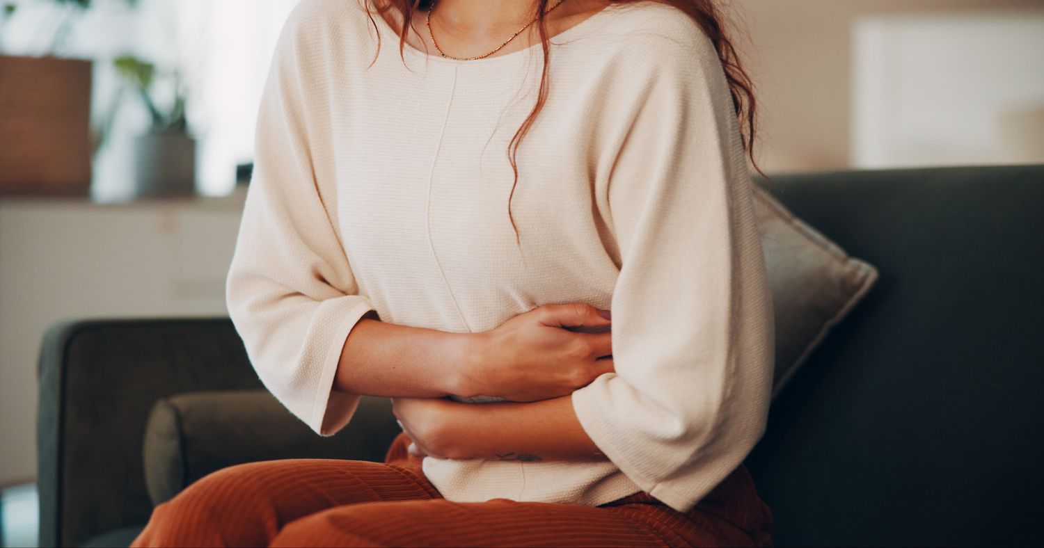 woman holding her stomach from bloating