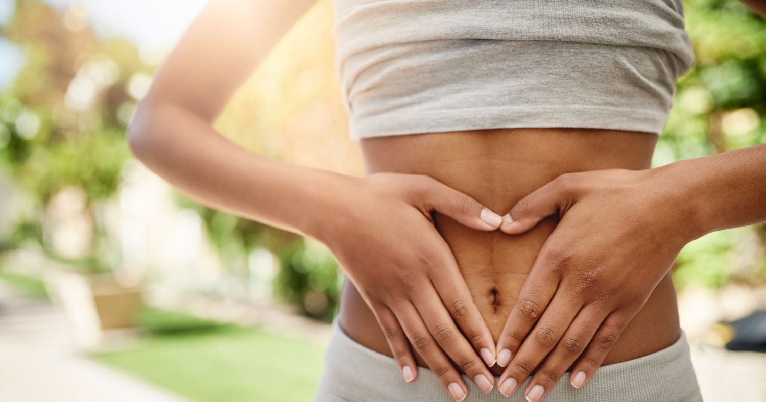 woman holding stomach due to gut issues