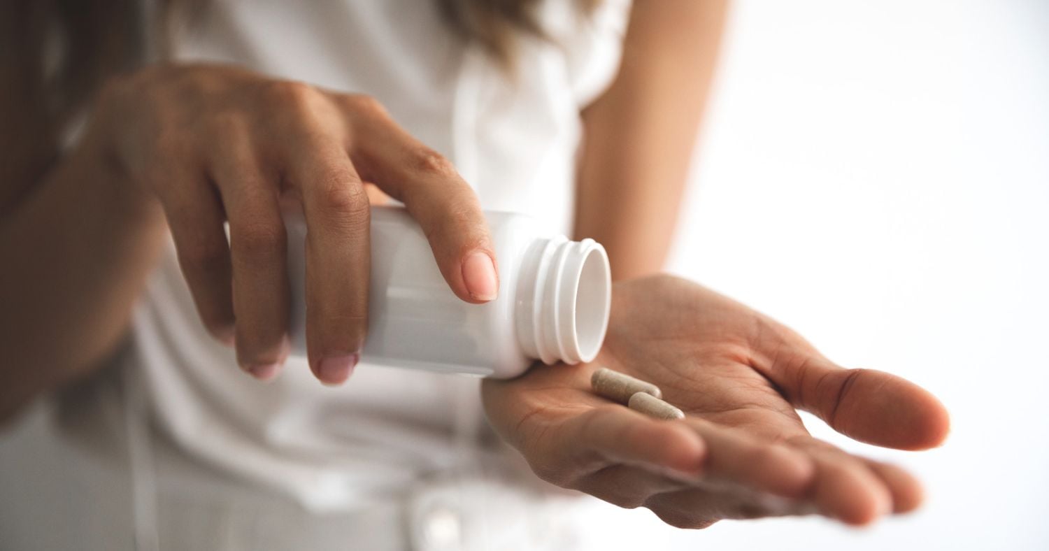 woman taking supplement for SIBO